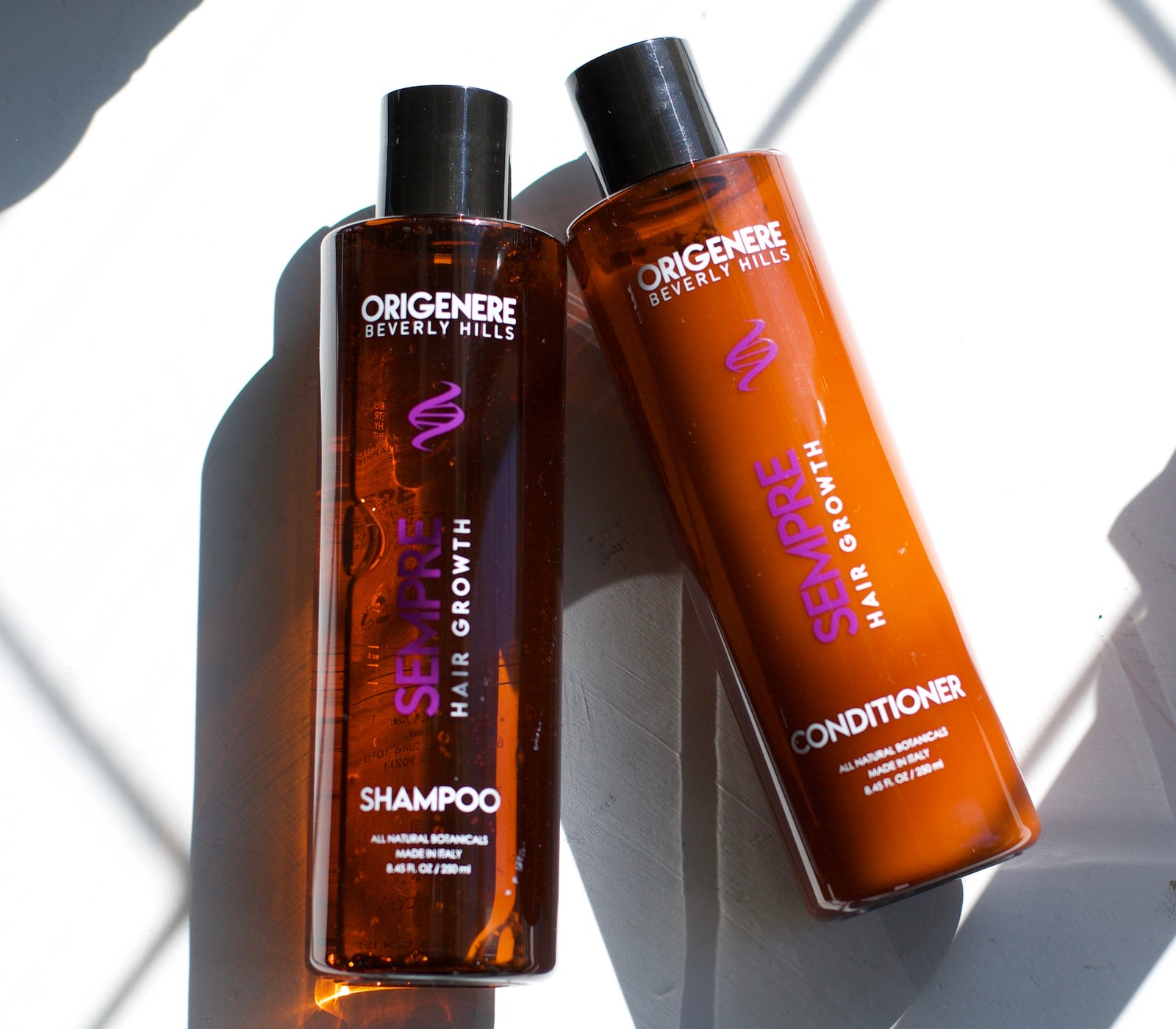 Sempre Shampoo and Conditioner bottle on white marble.