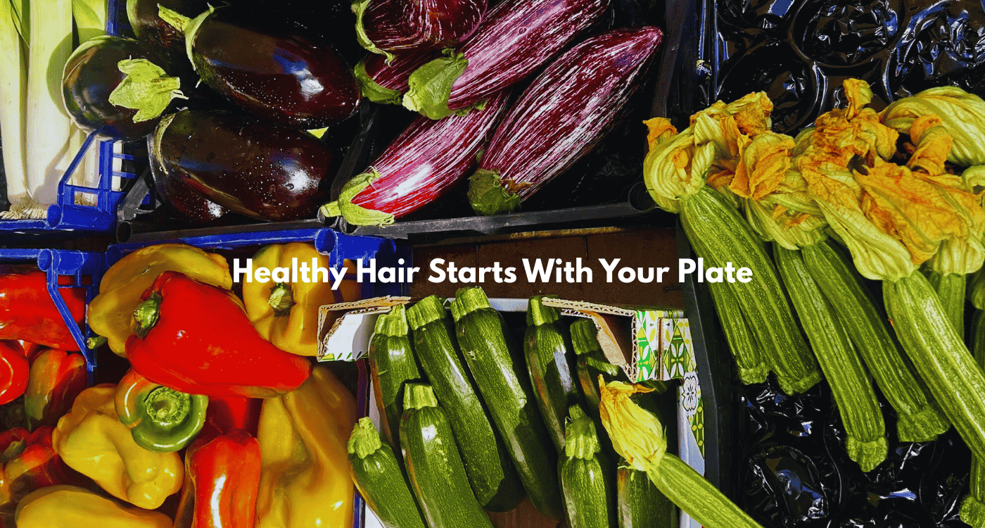 Colorful variety of fresh vegetables including bell peppers, zucchini, and eggplants at a farmers market, promoting nutrient-rich foods for healthy hair and scalp.