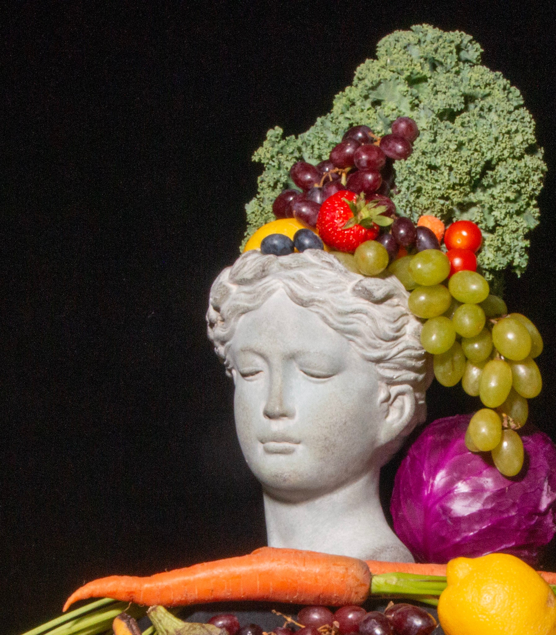 statue head with fruits and vegetables as hair