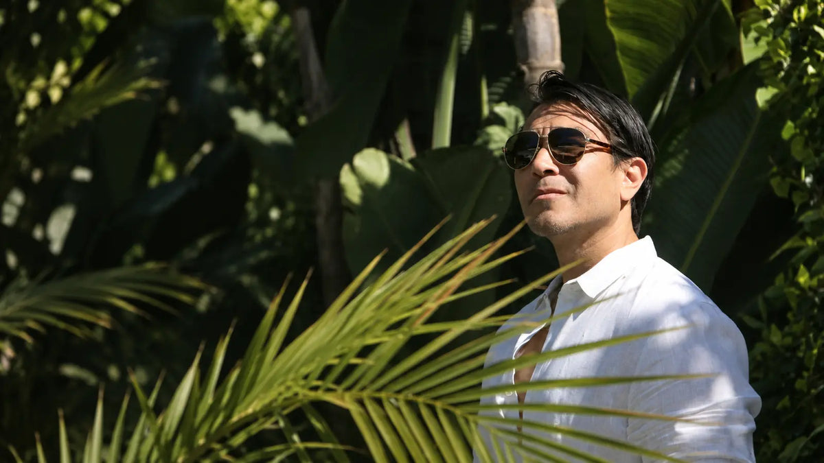 Man outdoors in sunlight illustrating seasonal hair shedding in late summer and fall