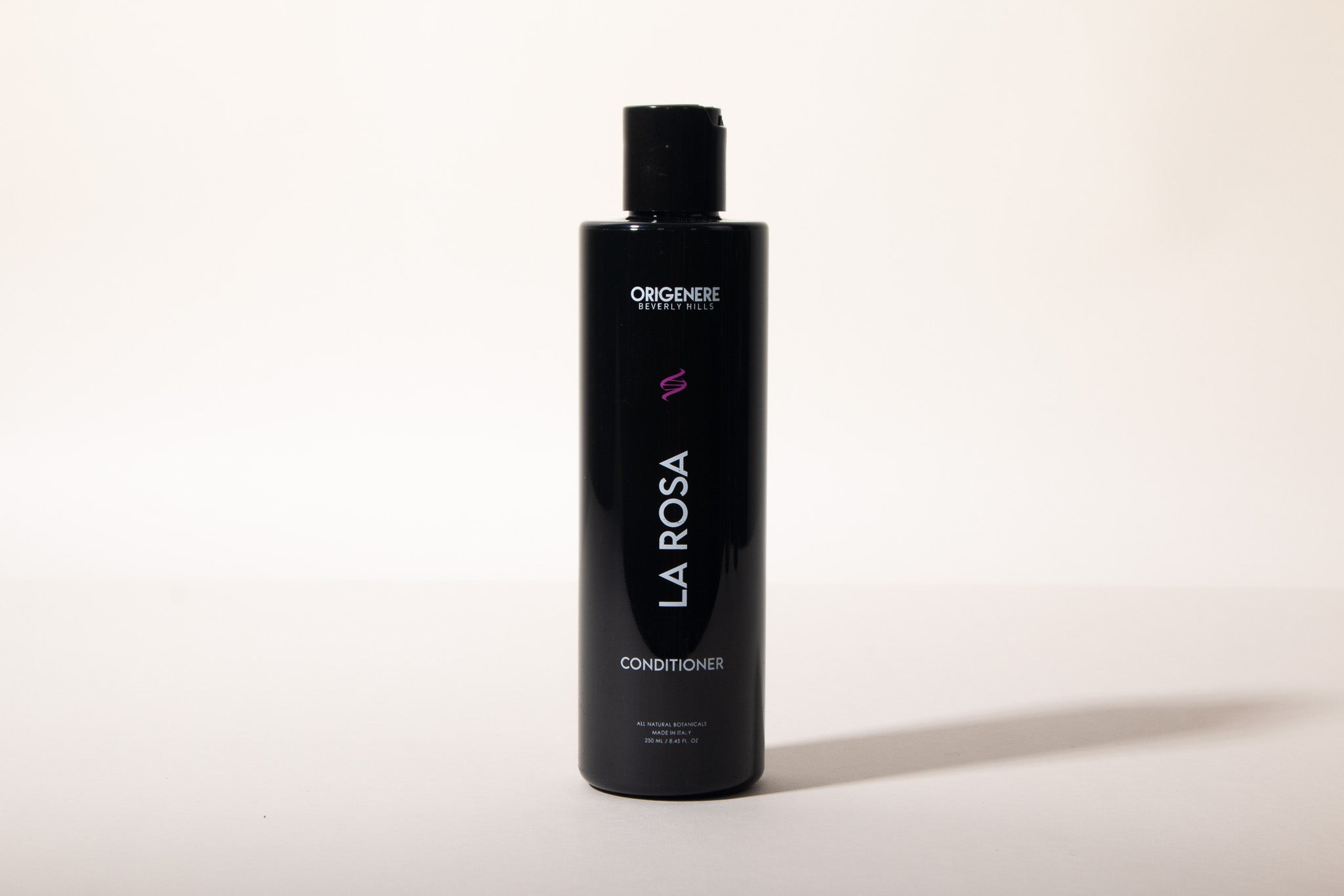 Black bottle of 'La Rosa' conditioner on a white background