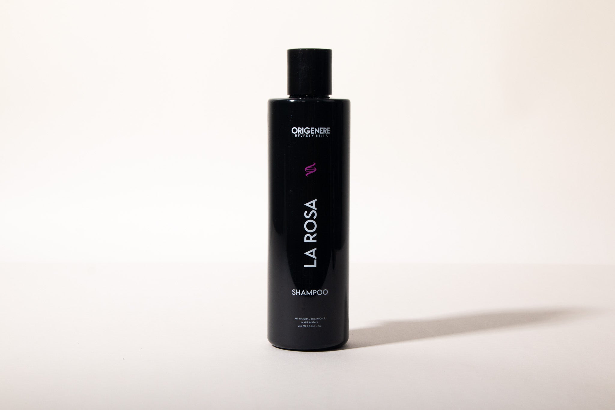 Black shampoo bottle labeled 'La Rosa' on a white background