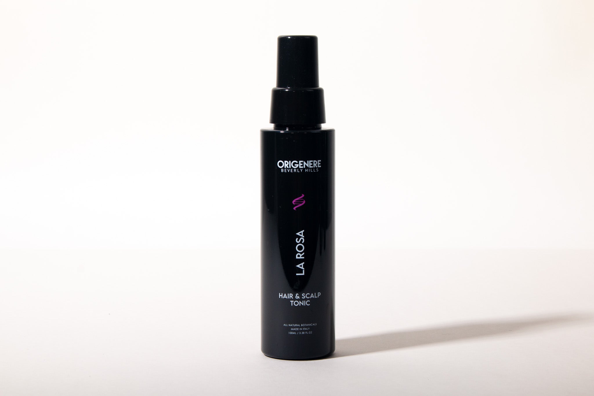 Black bottle of Larosa hair and scalp tonic on a white background